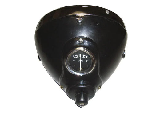 Black headlamp housing with circular lens and mounting bracket, triangular cover