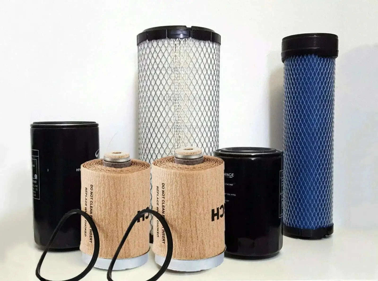 Tractor air filter pack with six cylindrical filters, beige and black and blue mesh