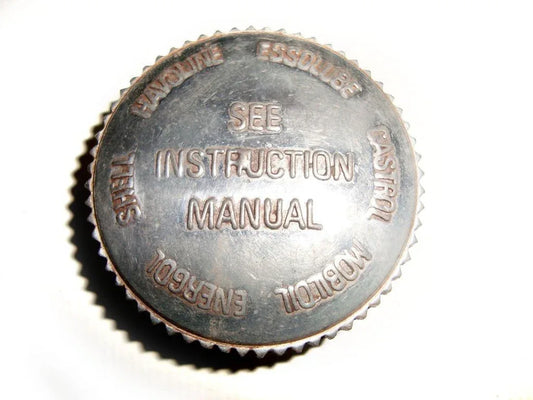 Metal oil tank filler cap with embossed text and serrated edge