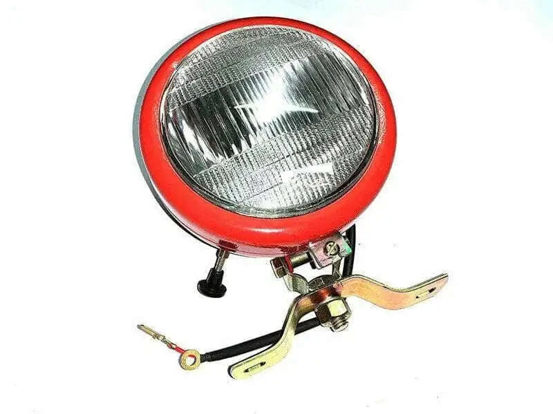 Round tractor work light with red rim, clear reflector, and mounting bracket