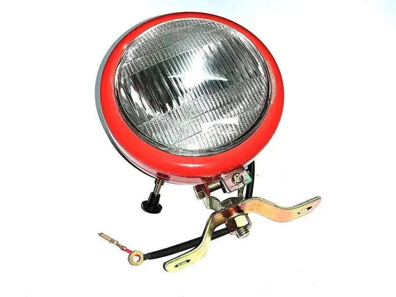 Round tractor work lamp with clear lens and red bezel, mounting bracket
