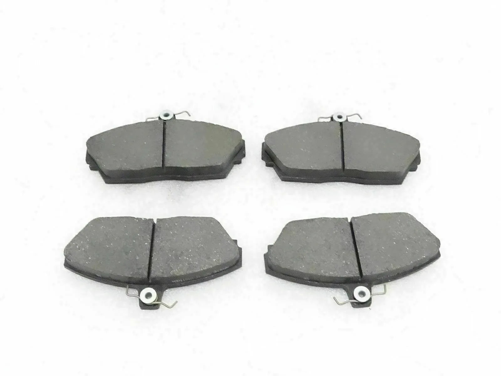 Disc brake pad set with four dark gray brake pads