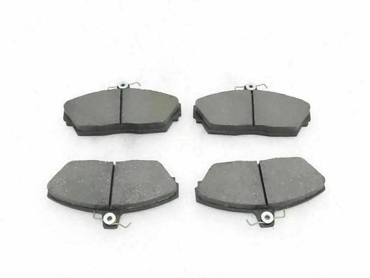 Disc brake pad set with four dark gray brake pads