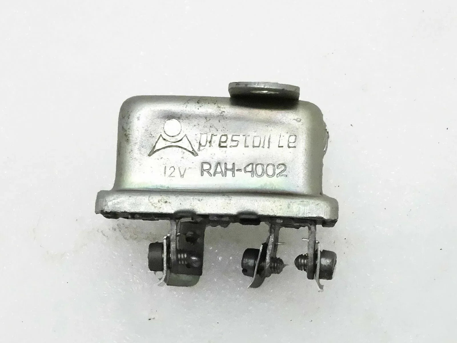 12-volt horn relay with metal housing and multiple electrical terminals