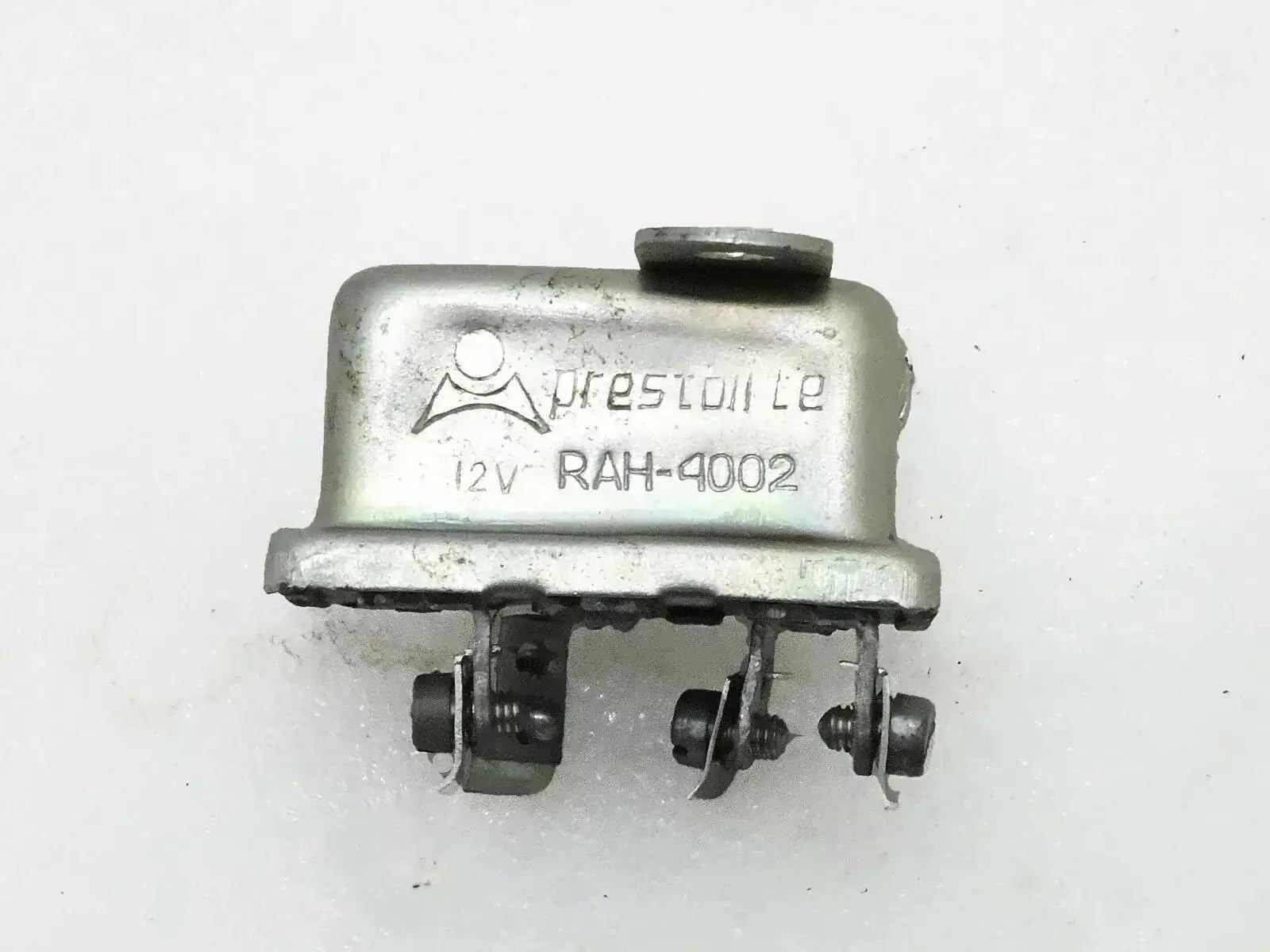 12-volt horn relay with metal housing and multiple electrical terminals