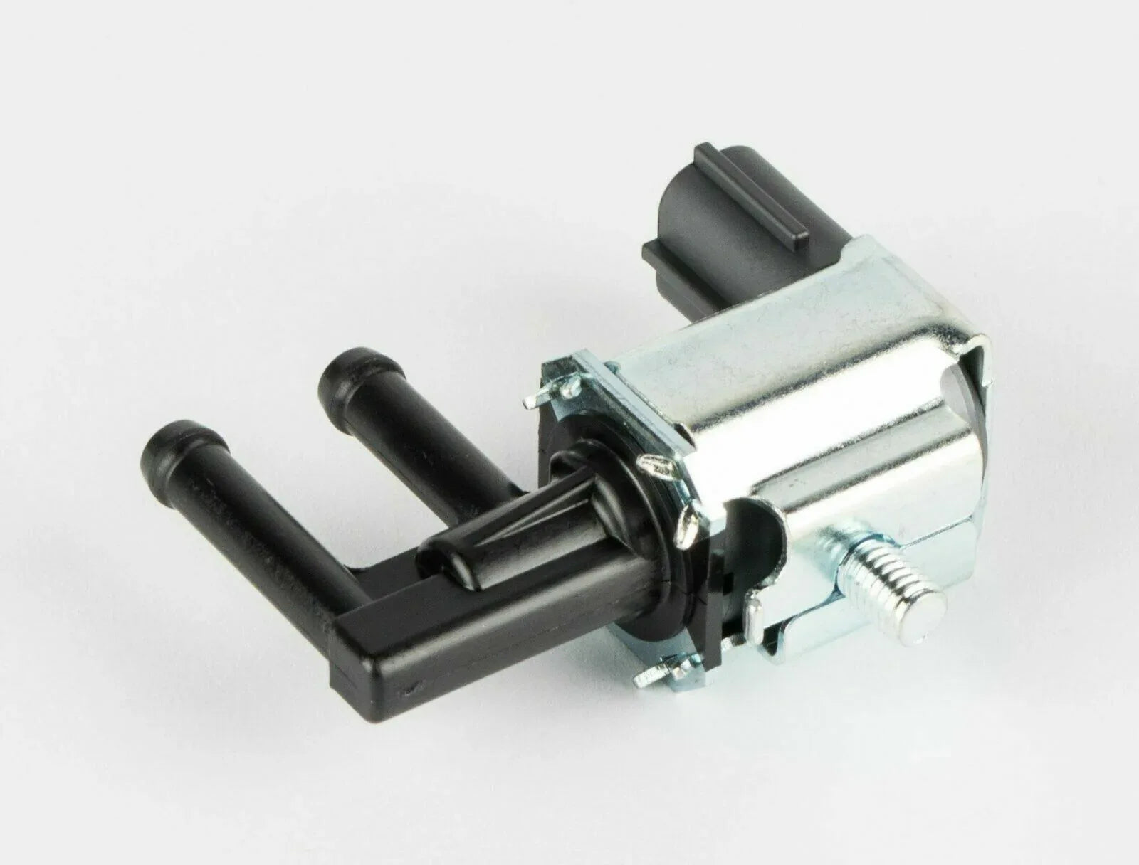 Emission purge valve canister with black vacuum hoses and metal electrical connector