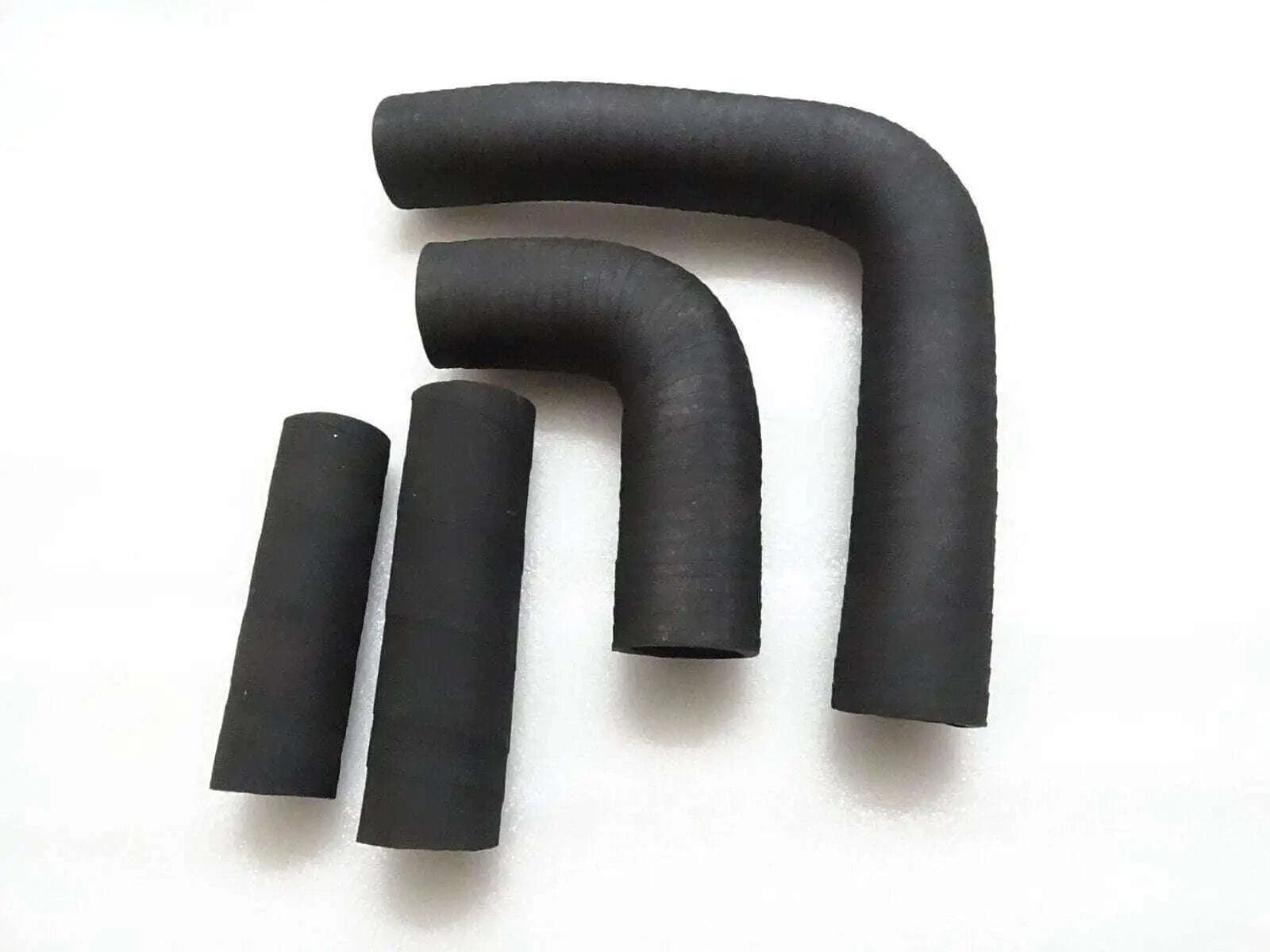 Black radiator hose set with four rubber hoses and elbows