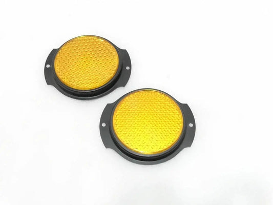 Pair of circular yellow reflectors with black bezels