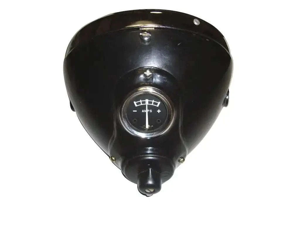 Black headlamp housing with circular lens and mounting bracket, triangular cover
