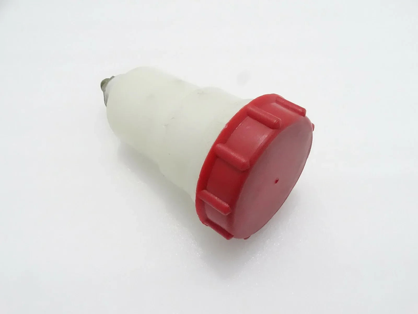 Plastic reservoir fit for JCB 3CX with a red cap for easy access and fluid storage