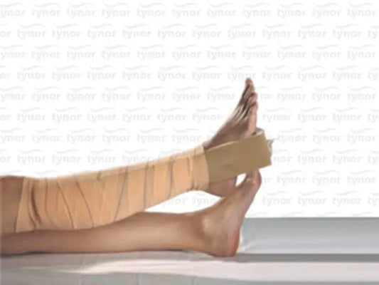 Beige padded foot traction liner with support straps, shown on a leg