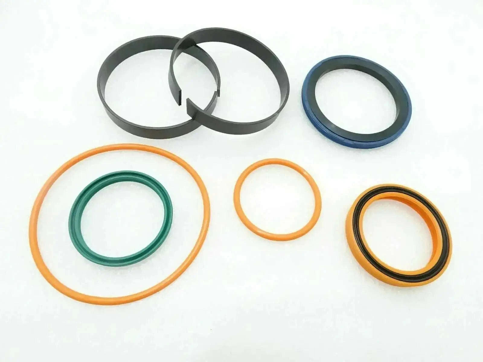 Seal kit with assorted O-rings and seals, including dark, orange, blue, and yellow rings