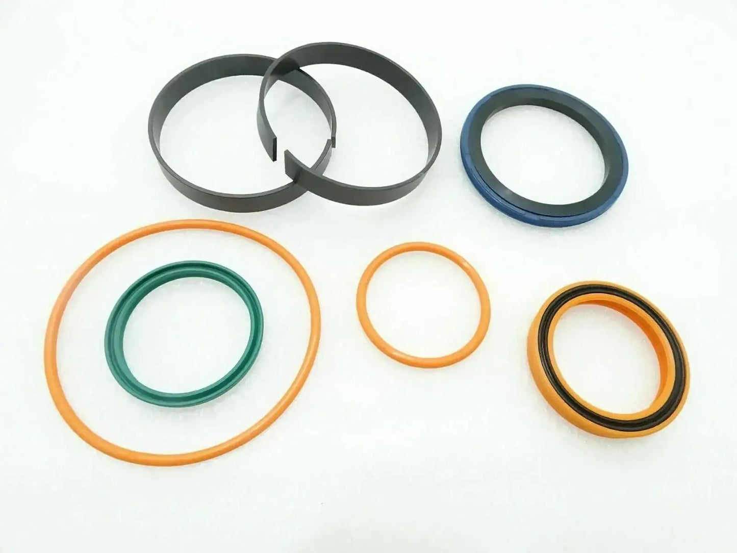 Seal kit with assorted O-rings and seals, including dark, orange, blue, and yellow rings