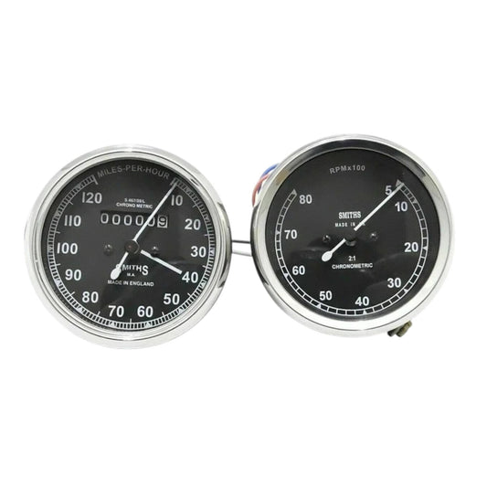 Speedometer gauge pair with chrome bezels, dual dials for mph and tach