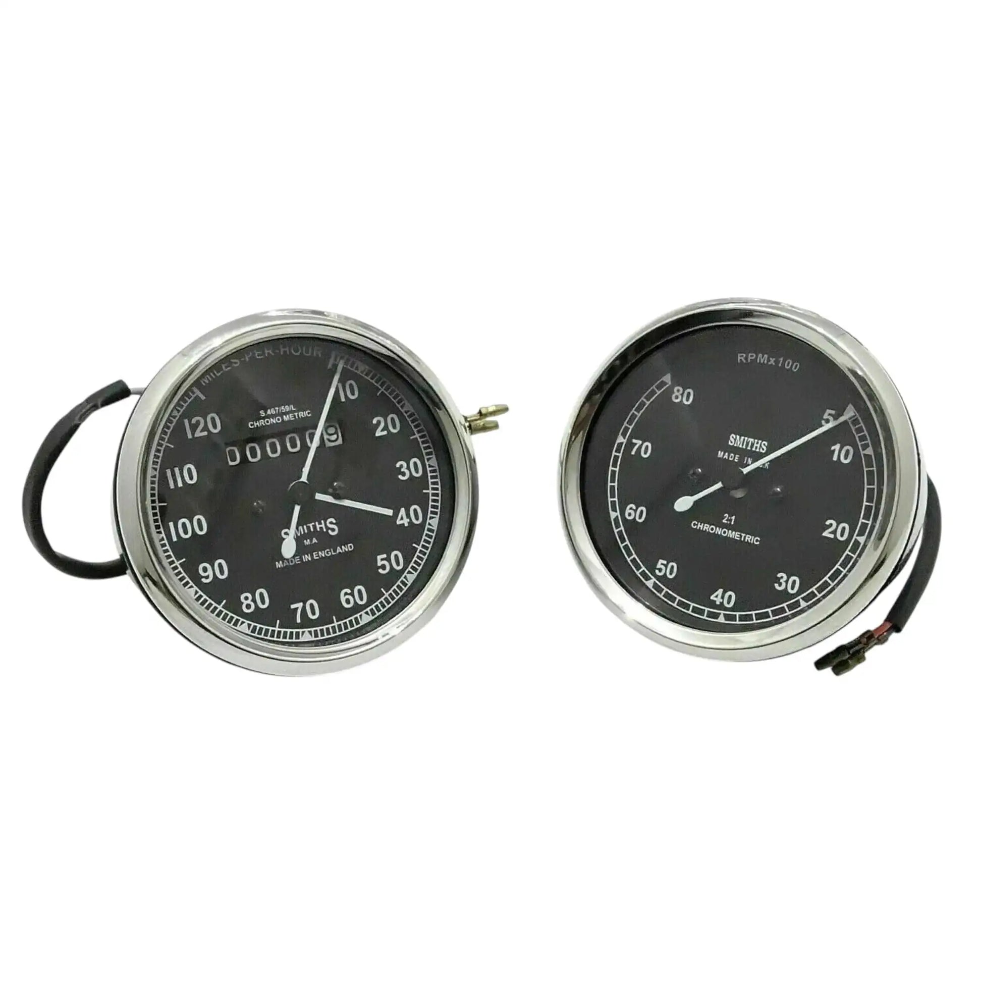 Speedometer gauge pair with chrome bezels, black faces, visible wiring on one unit