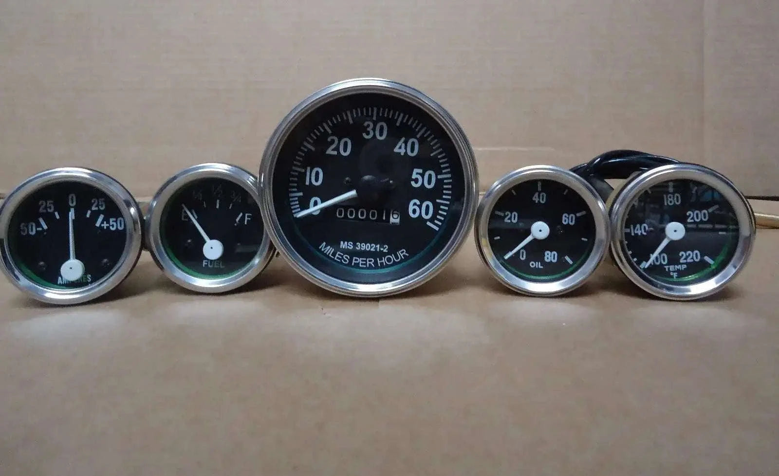 Analog vehicle gauges kit with chrome bezels, five round dials and black faces