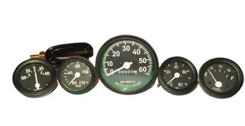 Automotive gauge kit with multiple round black-faced meters, including speedometer and fuel
