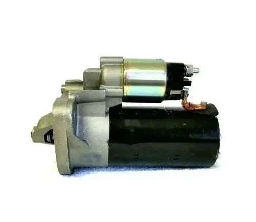 Starter motor with silver solenoid and dark housing, visible electrical terminals