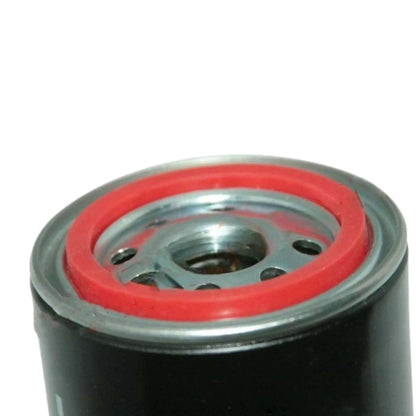 Diesel engine oil filter underside with red seal, central metal outlet holes