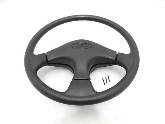 Black steering wheel with horn button center and three-spoke spokes