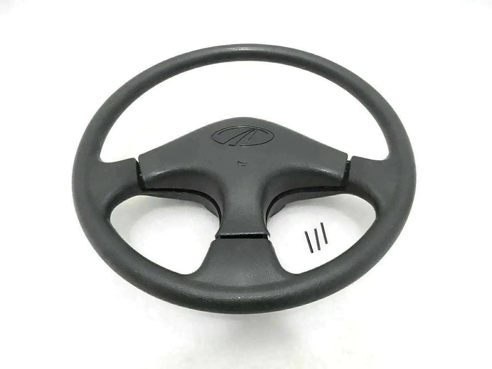 Black steering wheel with horn button center and three-spoke spokes