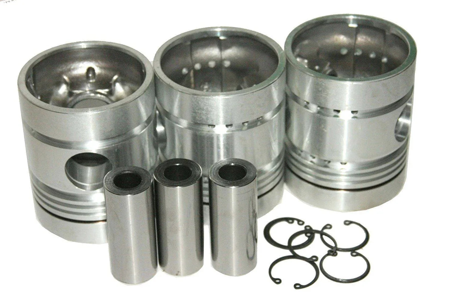 Piston kit with rings for tractors, includes three aluminum pistons, steel sleeves, and retaining clips, Steiner tractor parts Michigan