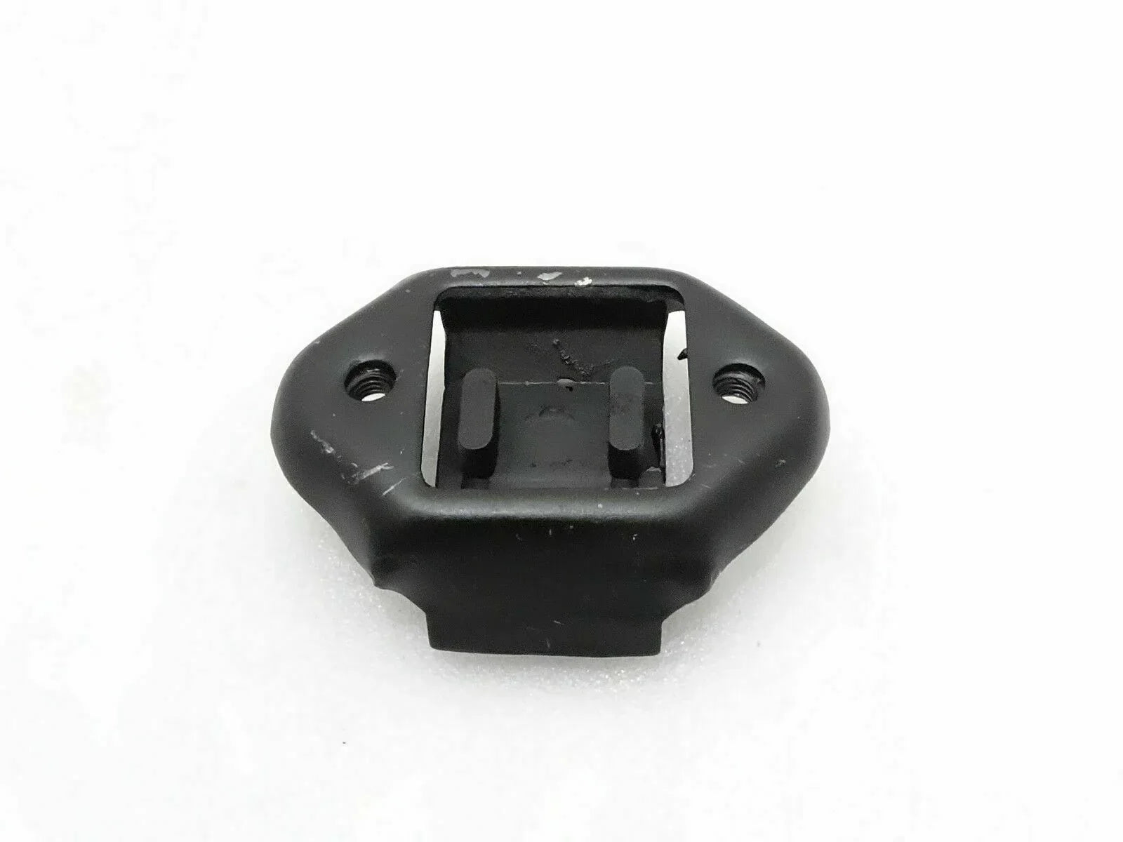 Black rear transmission mounting bushing with bolt holes and metal bracket
