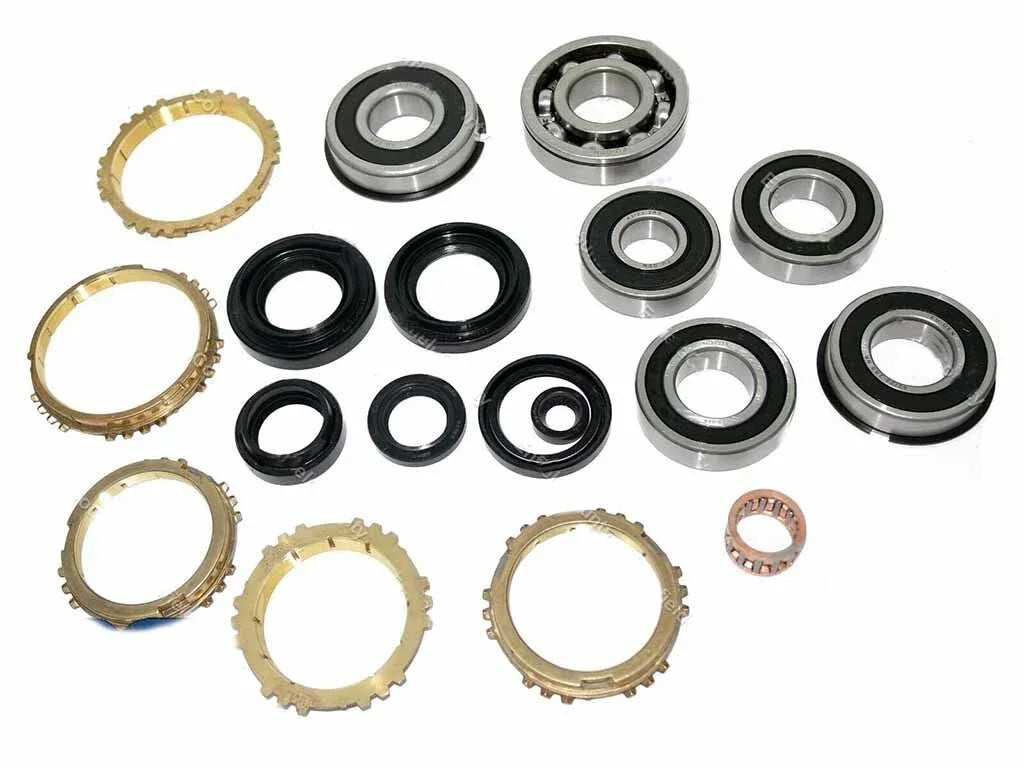 Manual transmission rebuild kit parts set with synchro rings, bearings, and seals