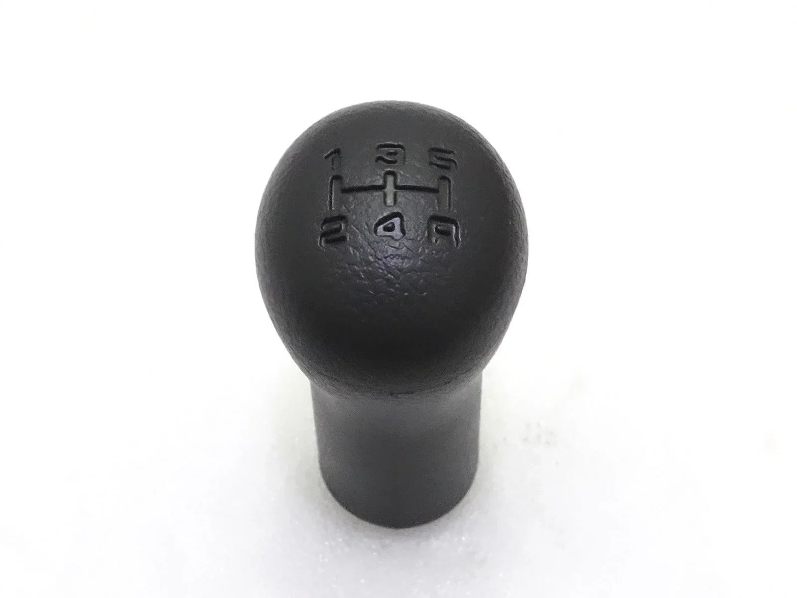 Black gear shift knob with embossed shift pattern on round top
