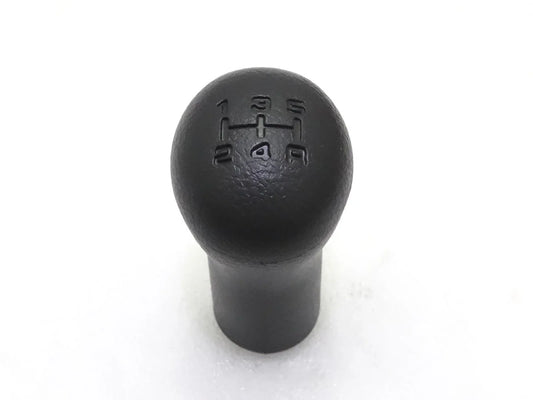 Black gear shift knob with embossed shift pattern on round top