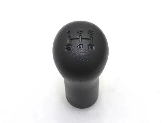 Black gear shift knob with embossed shift pattern on round top