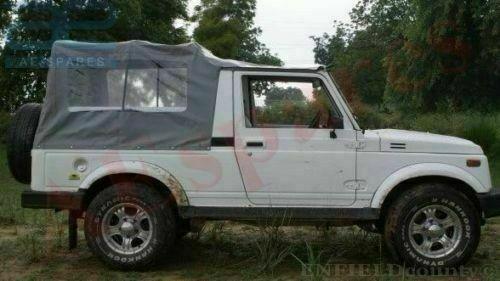 Gray soft-top SUV with long roof and canvas side cover