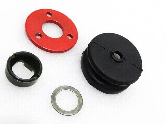 Suzuki Samurai transfer case kit components including a red plate and black rubber parts