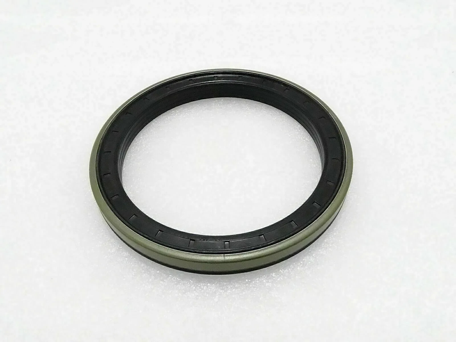 Piston seal ring with black rubber lip and green outer body