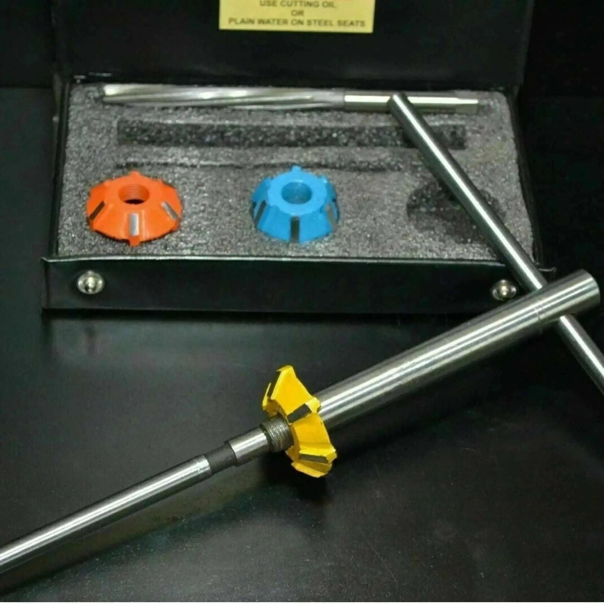 Carbide valve seat cutter set with two color-coded cutters and steel shaft for precise valve seat cutting