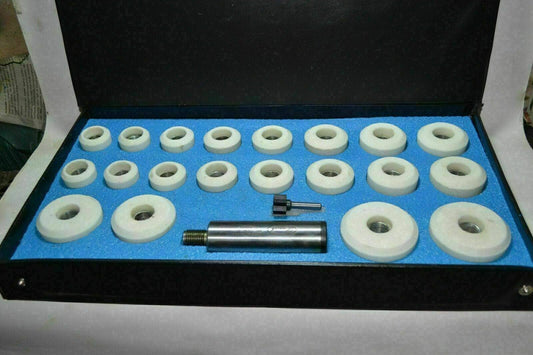 Valve seat grinder kit with various stones and holder, organized in a durable case