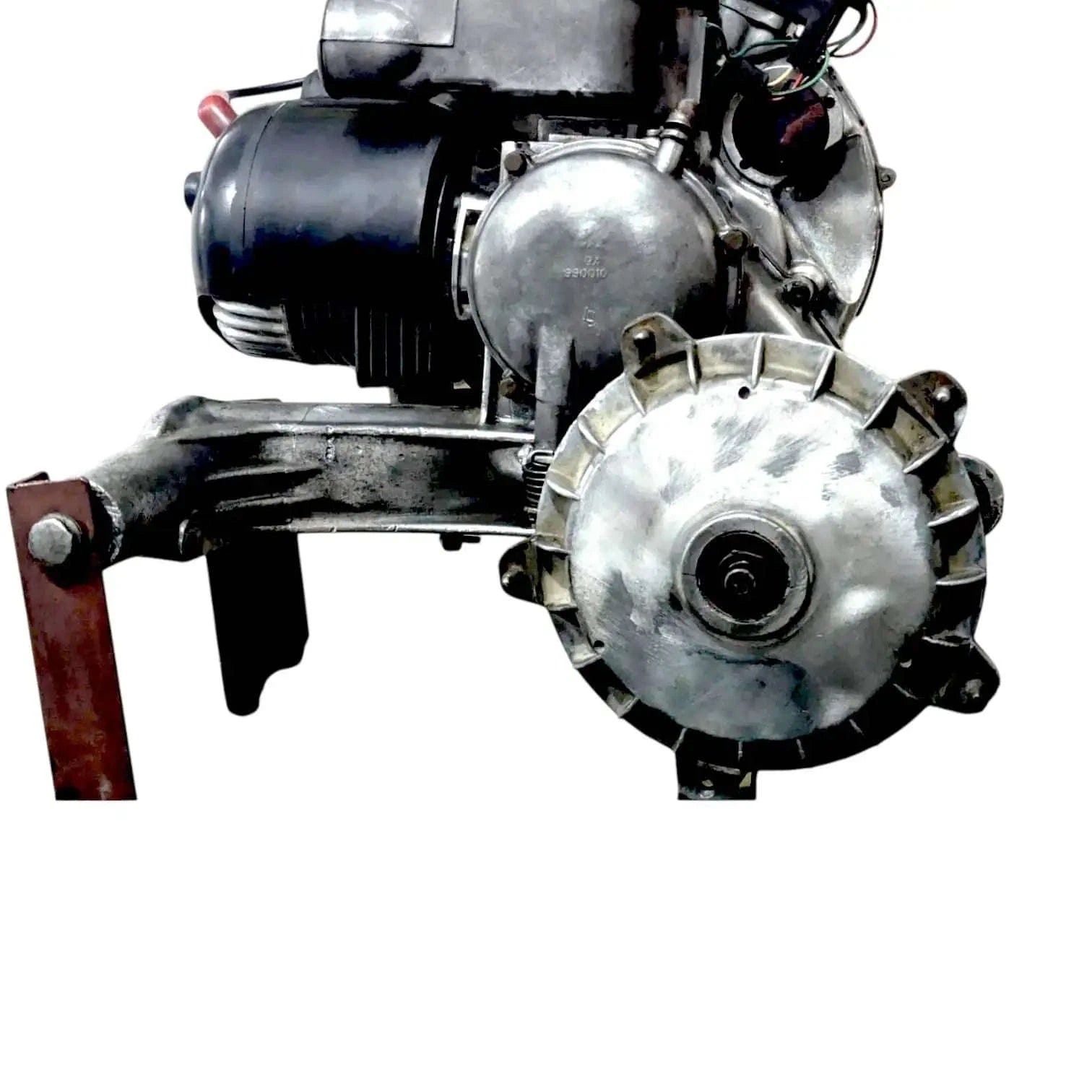 Complete engine assembly front view with silver flywheel cover and black cylinder head