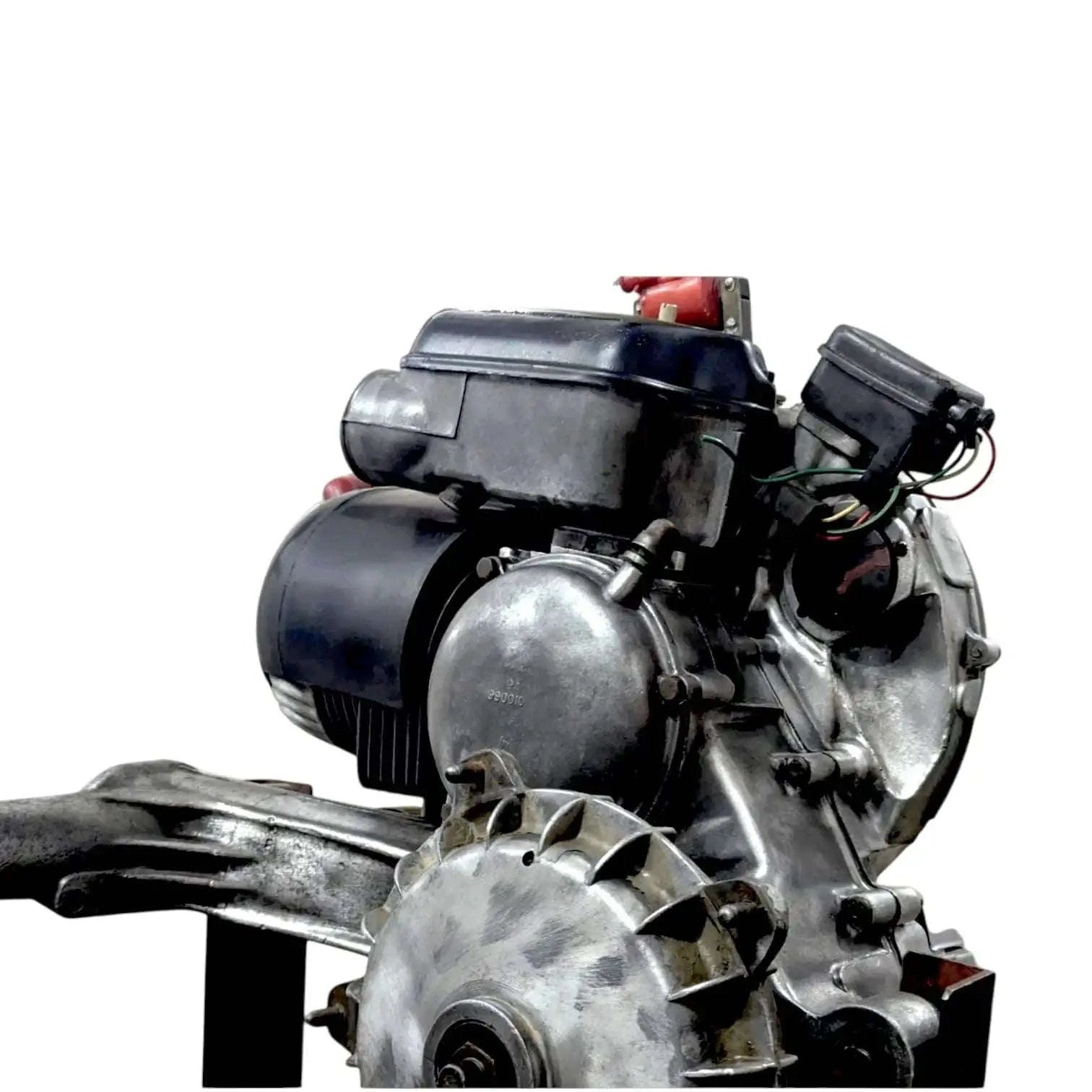 Complete engine assembly side view with black and silver engine case and red airbox