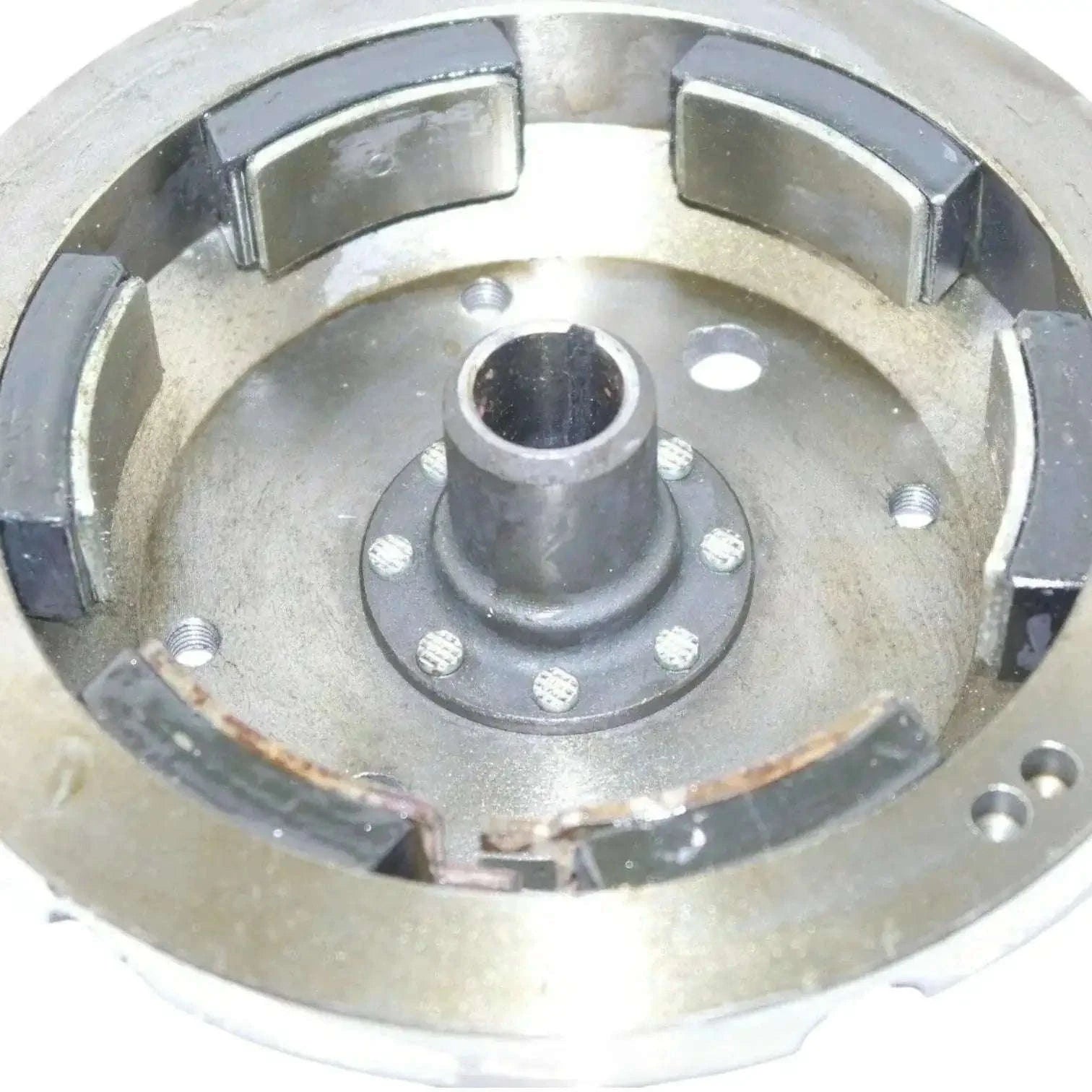 Metal flywheel housing with central hub and mounting points