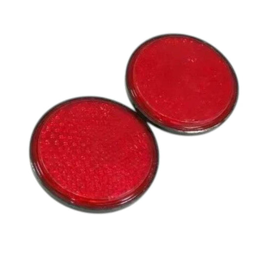 Vintage red reflector pair with a round design for classic vehicle restoration