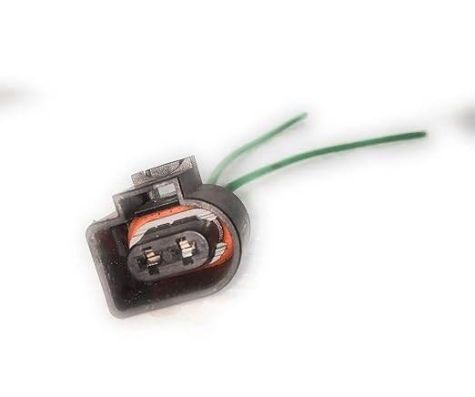Close-up of Volkswagen Vento fuel injector harness with green wires and electrical connector