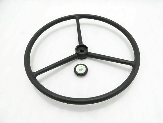 Black tractor wheel steering, durable steel construction, designed for optimal control and maneuverability