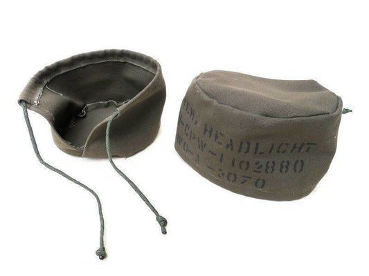Aftermarket Willys Jeep headlight covers in olive drab fabric for protecting headlights