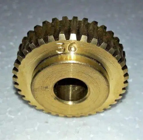 Brass worm gear with toothed ring and stamped 777 marking, metal finish